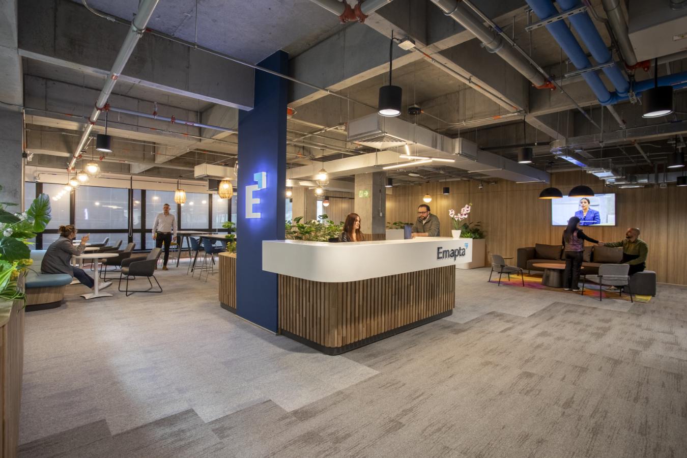 Emapta Offices - Modern reception desk featuring industrial concrete columns and wood slats - Contract Workplaces.jpg